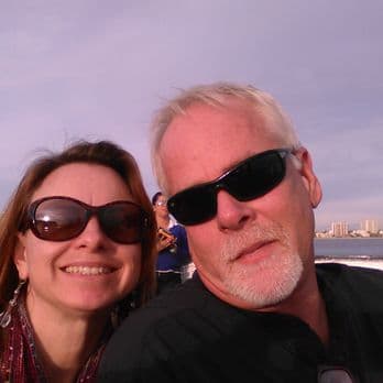 Mark and Monica, the husband and wife owners of Fair Deal Plumbing, photographed together outdoors.